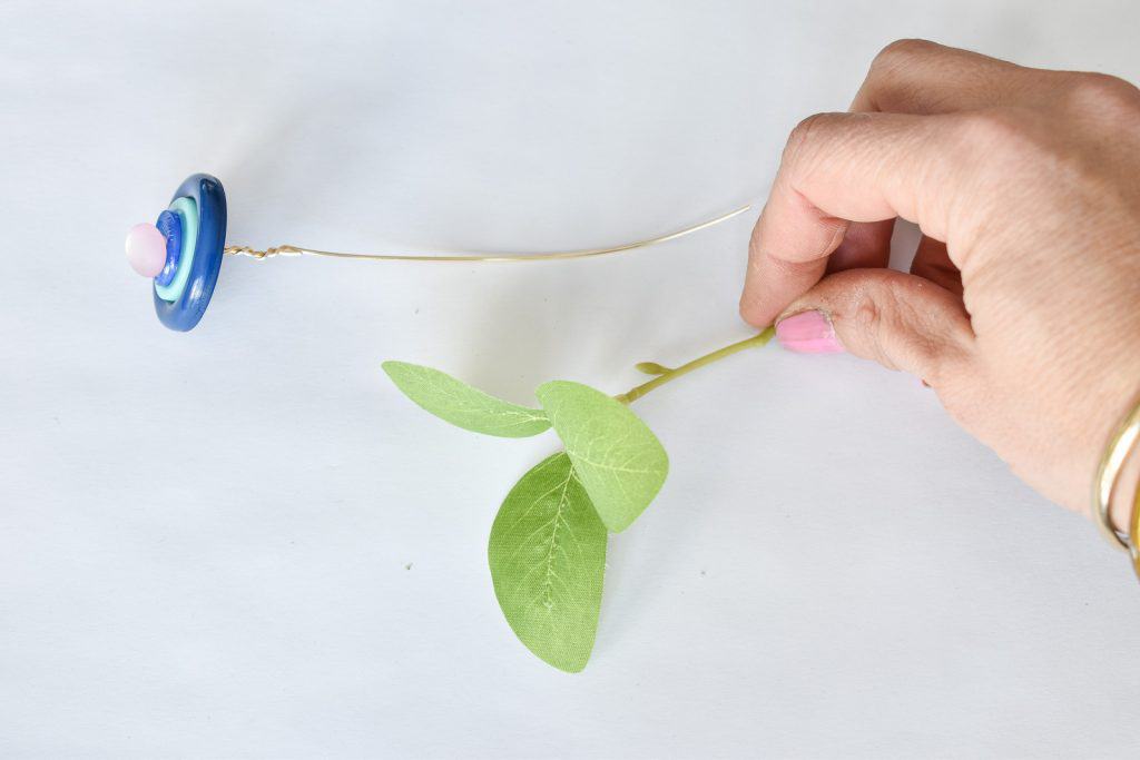 wrap faux leaves into the button flower stems