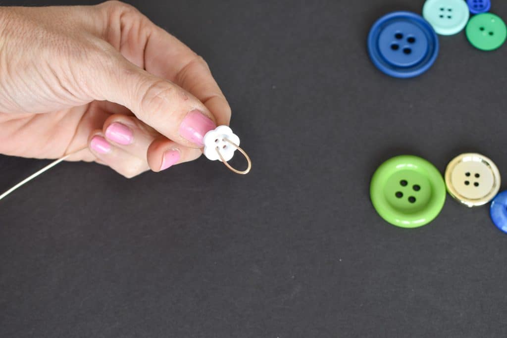 thread buttons onto wire