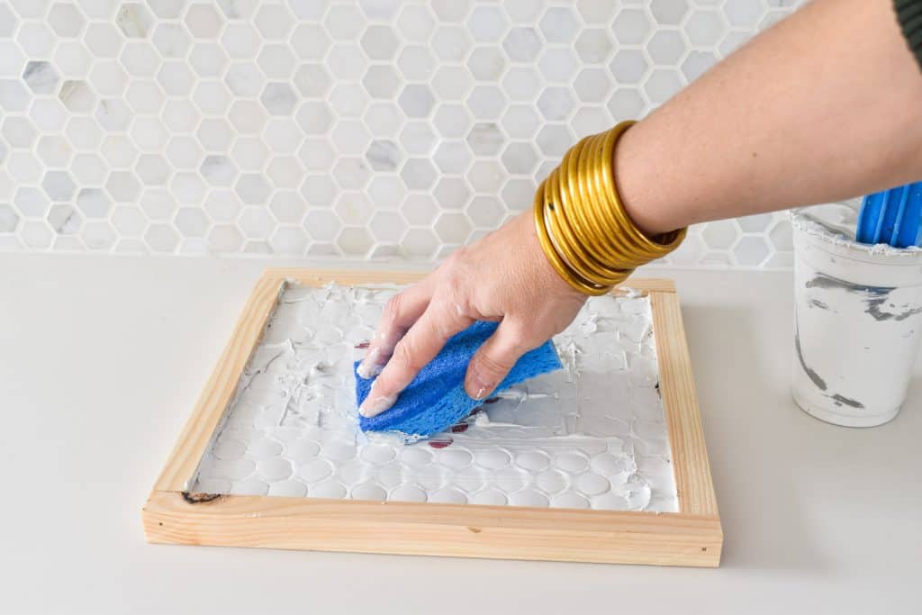 grout penny tiles on trivet