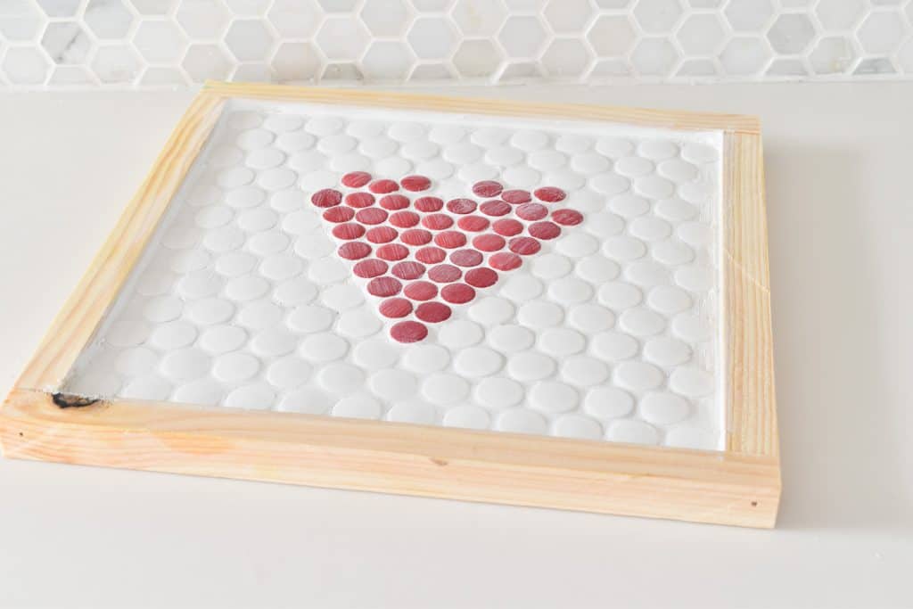 grout penny tiles on trivet